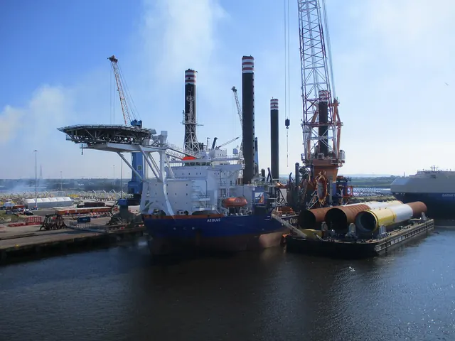 An offshore installation vessel docked beside turbine towers