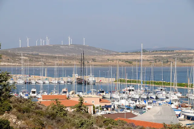 Wind turbines on a ridge above a marina