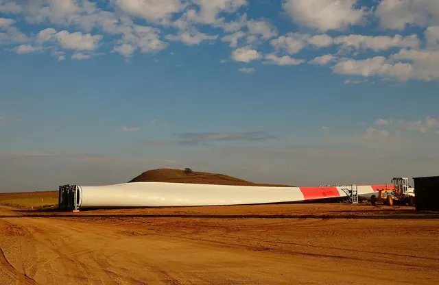 A turbine blade lying on red earth before installation
