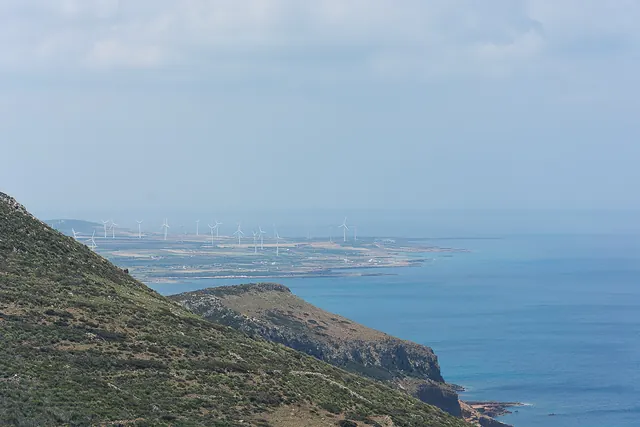 Wind turbines on a headland above the sea at Cap Bon