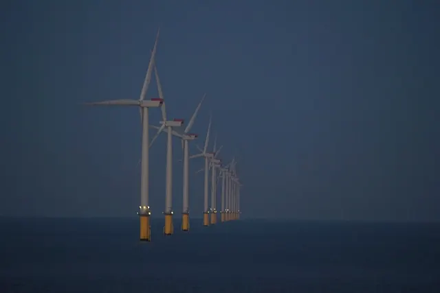 A row of offshore wind turbines in the Thames Estuary