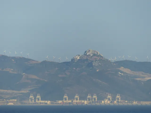 Wind turbines on the hills above the port of Tanger Med, seen across the strait