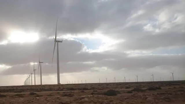 A wind turbine under breaking cloud at Tarfaya