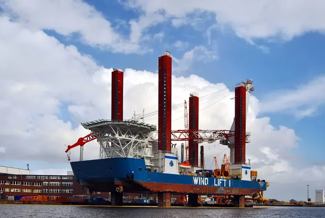 A jack-up installation vessel moored in port